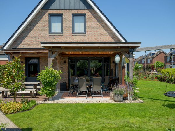 Achteraanzicht van de woning met terras voorzien van overkapping